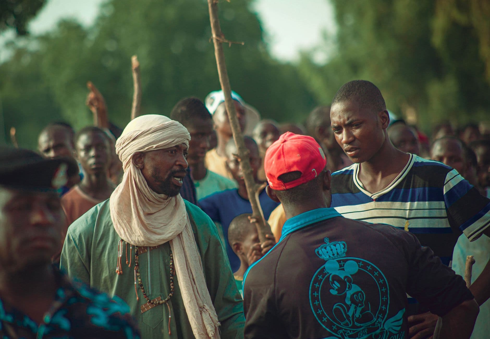 A lively outdoor gathering with people interacting in a vibrant community setting.