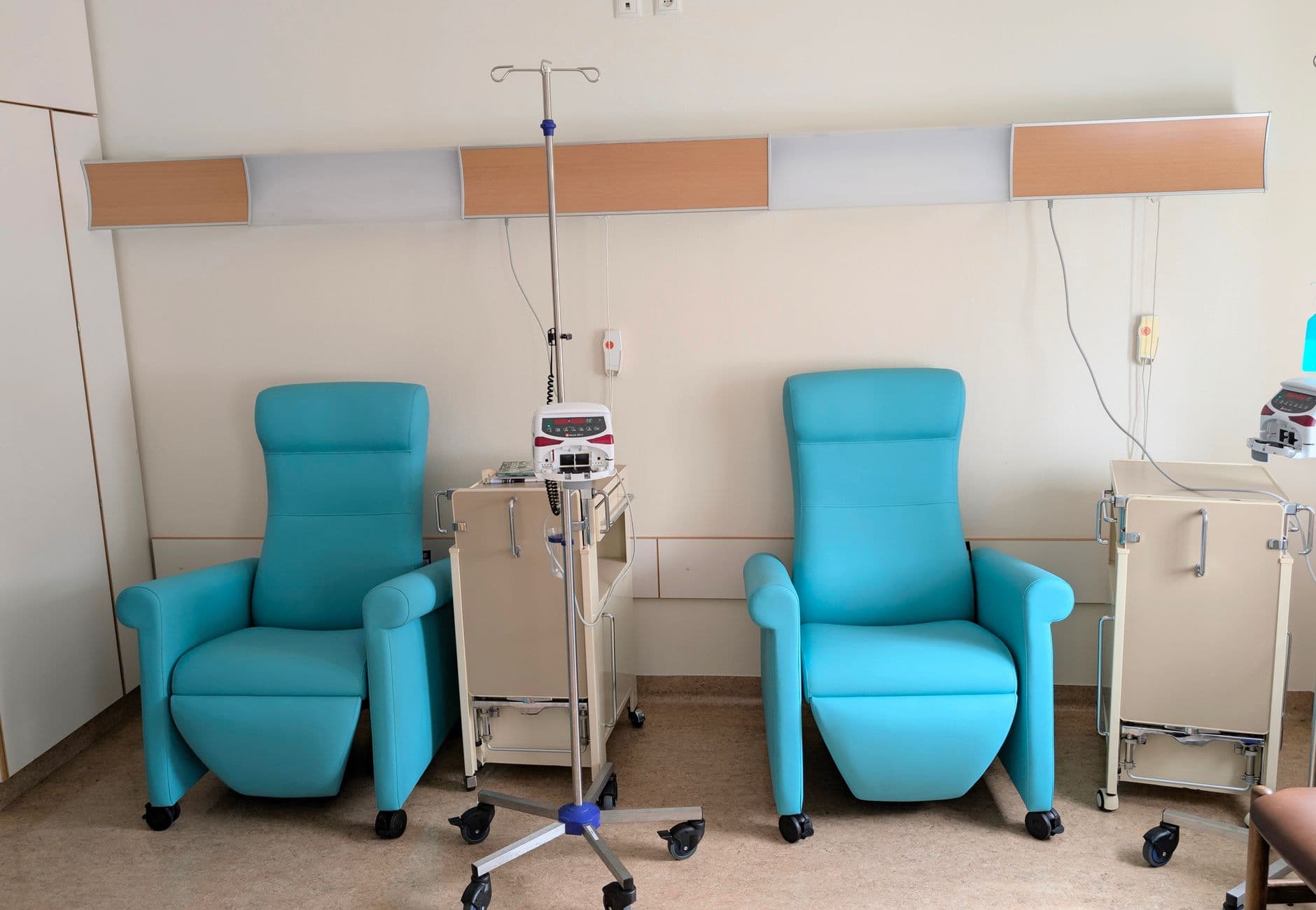 Calm hospital room featuring infusion chairs and equipment for chemotherapy treatment.